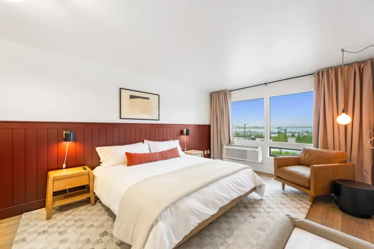 Modern bedroom with large window and scenic view