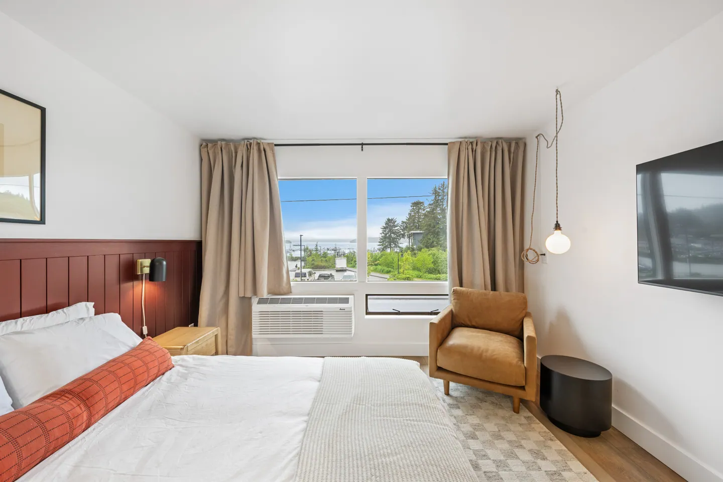 Modern bedroom with large window and cozy decor