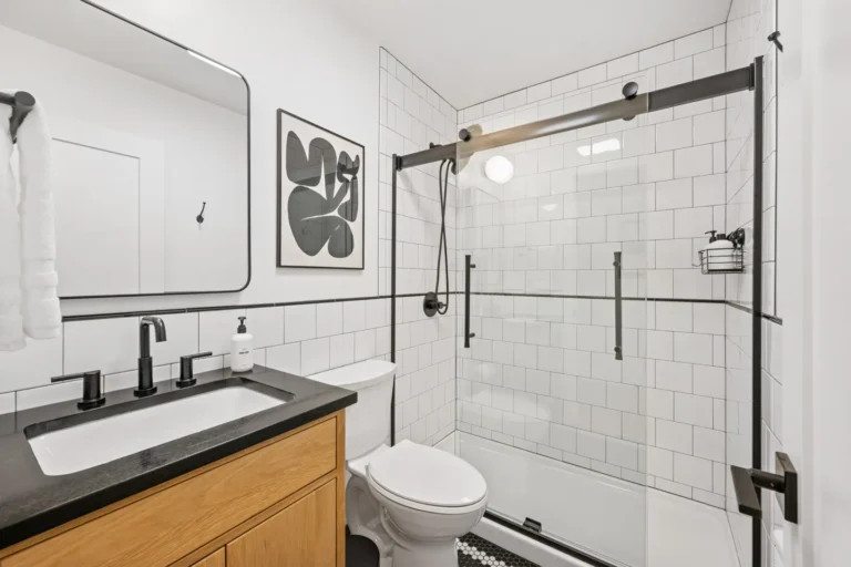 Modern bathroom with glass shower and black fixtures
