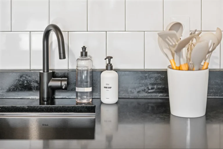 Modern kitchen sink with soap and utensils