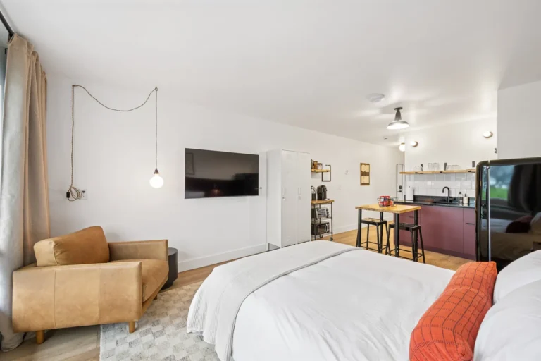 Modern studio apartment with kitchen and bed area