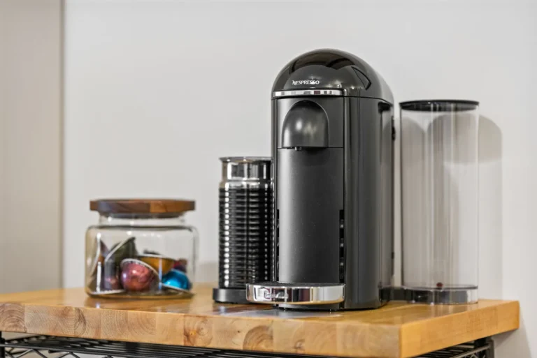 Coffee maker with capsules on wooden counter