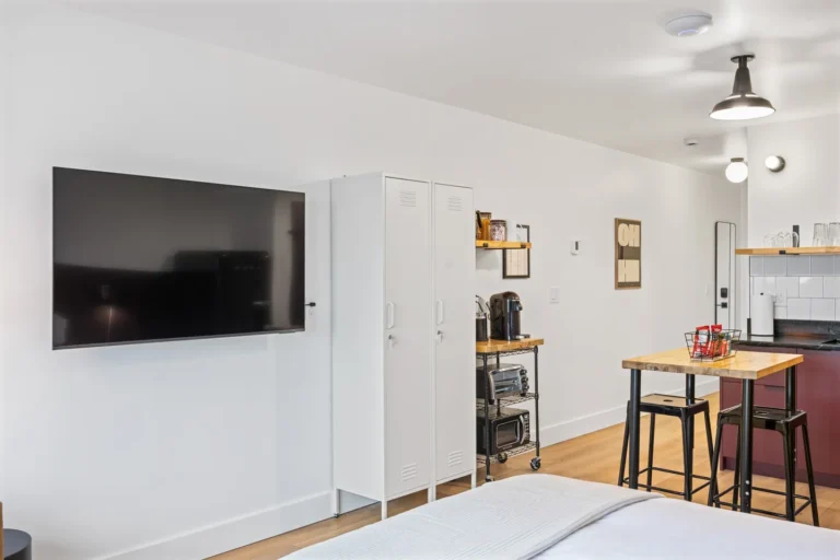 Modern studio kitchen with TV and dining area