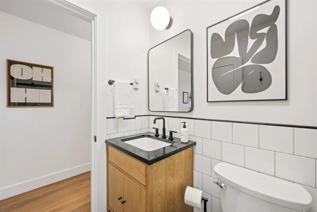 Modern bathroom with wood vanity and black fixtures