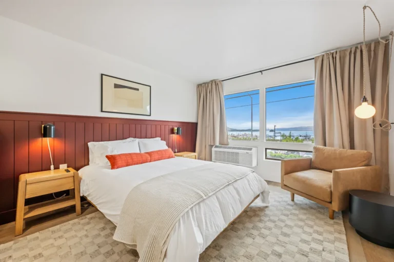 Modern bedroom with large windows and cozy decor