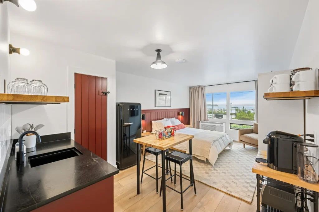 Modern studio with kitchen and bed near window view