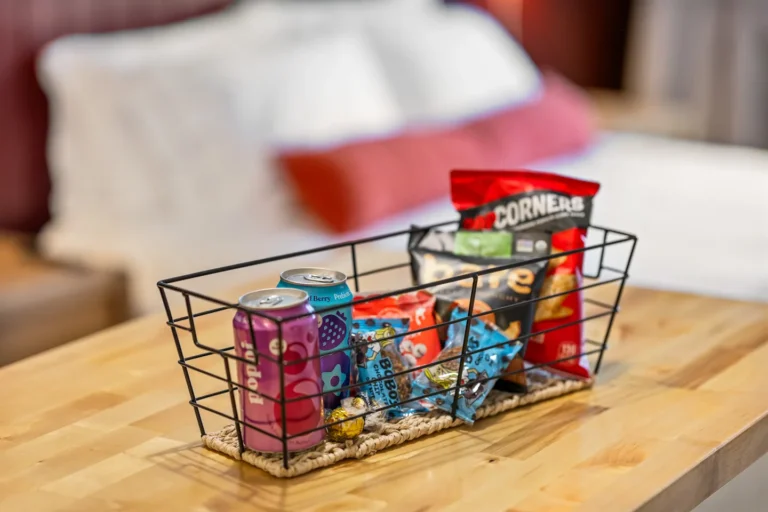 Snack basket with chips and drinks on table