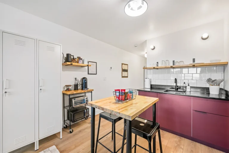 Modern kitchen with purple cabinets and wooden island