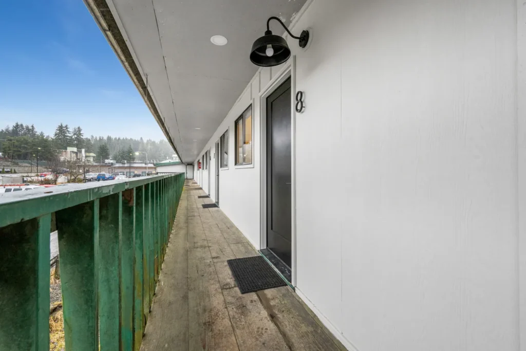 Outdoor motel hallway with room doors