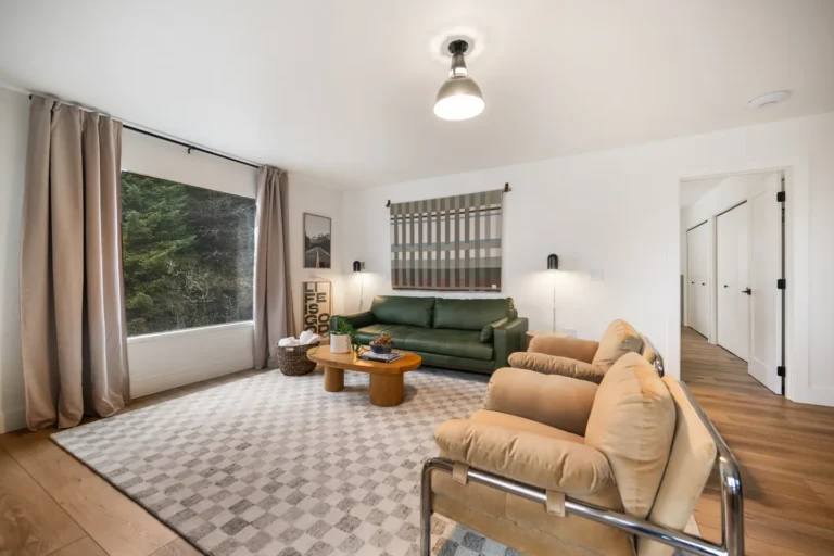 Modern living room with green sofa and large window