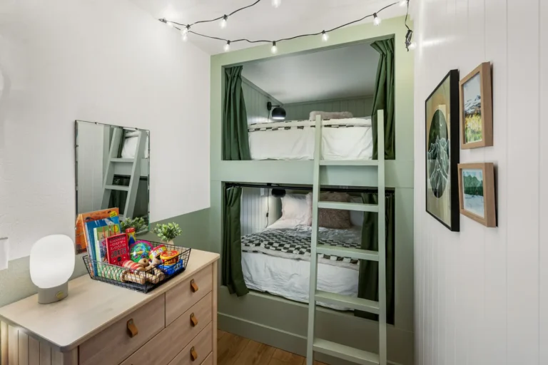 Cozy bedroom with green bunk beds and dresser.
