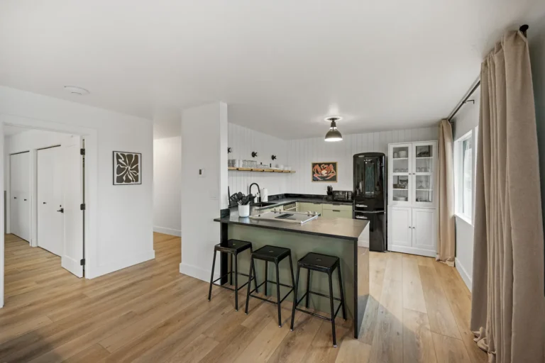 Modern kitchen with black appliances and wood flooring