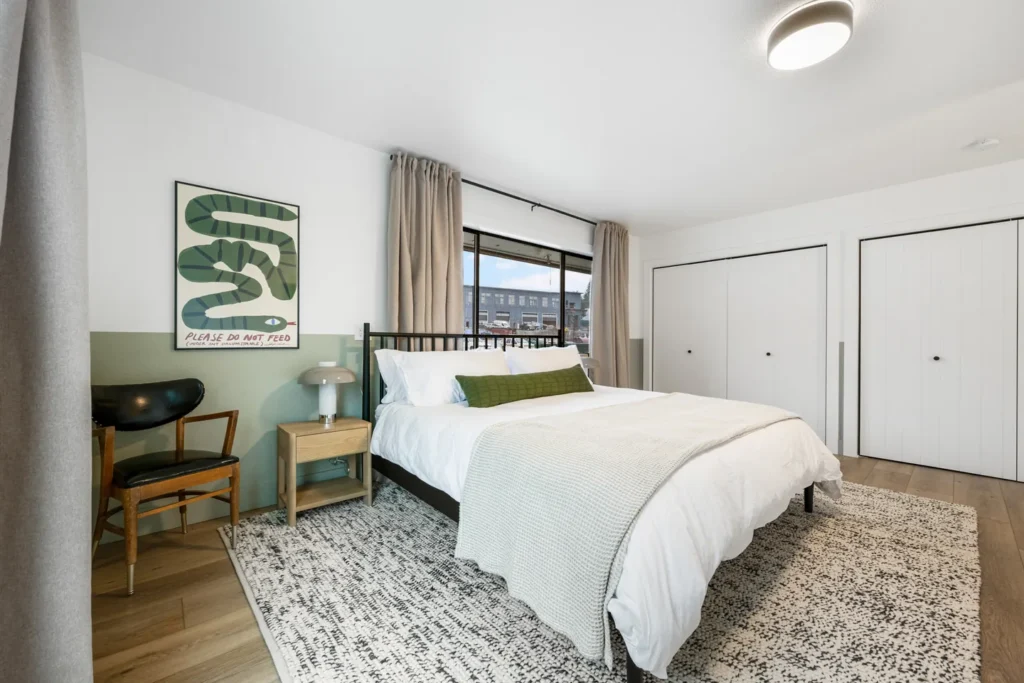 Modern bedroom with large window and cozy decor