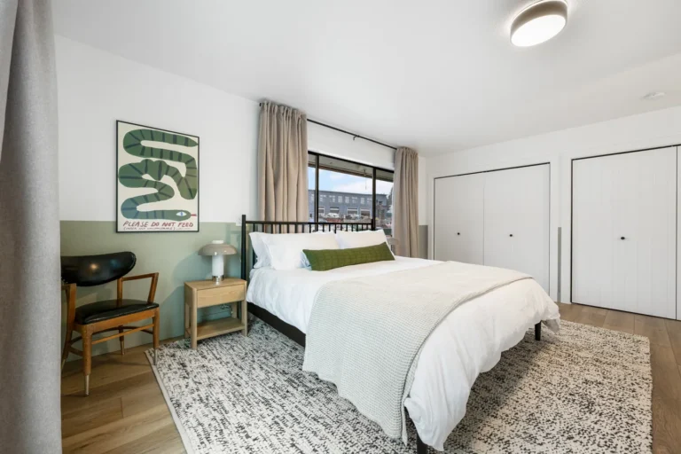 Modern bedroom with large window and cozy decor