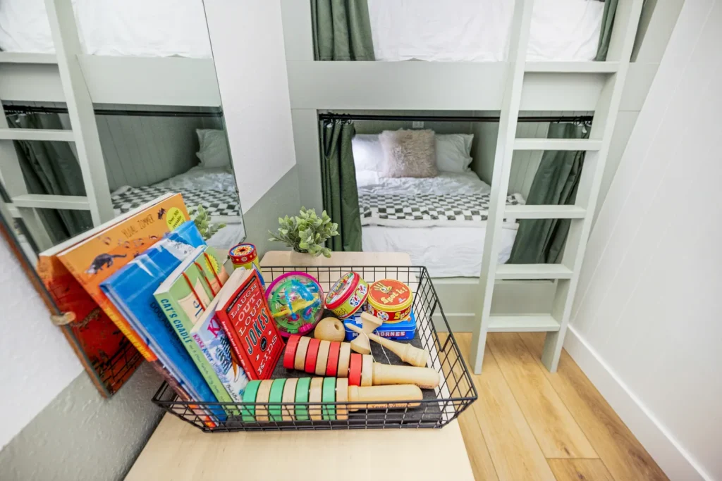 Kids bunk bed room with books and toys