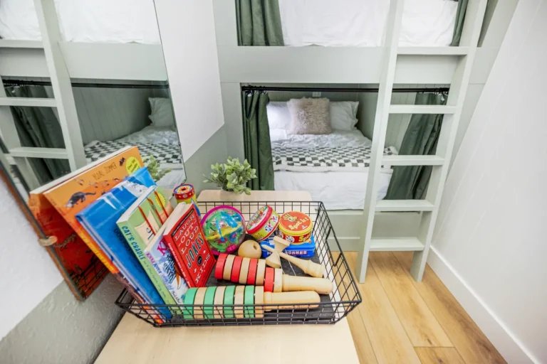 Kids bunk bed room with books and toys