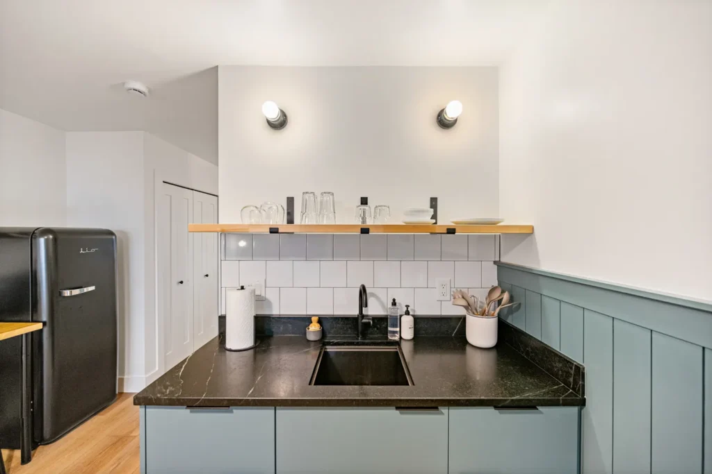 Modern kitchen with black countertop and open shelving