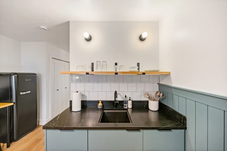 Modern kitchen with black countertop and open shelving