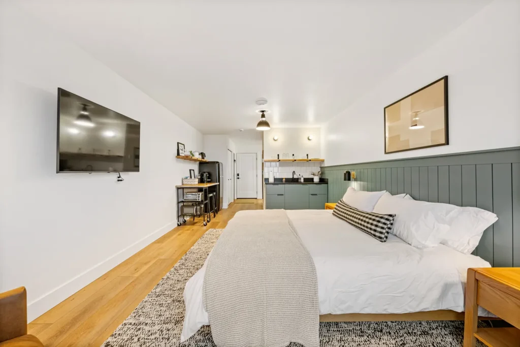 Modern studio bedroom with kitchenette and TV