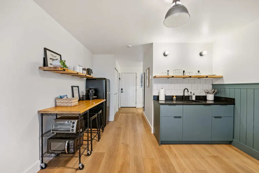 Modern kitchen with wooden floors and green cabinets