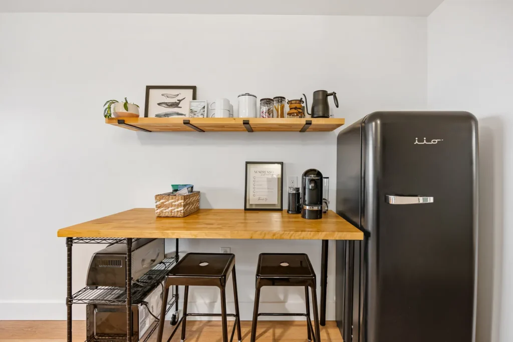 Modern kitchen corner with black fridge and table