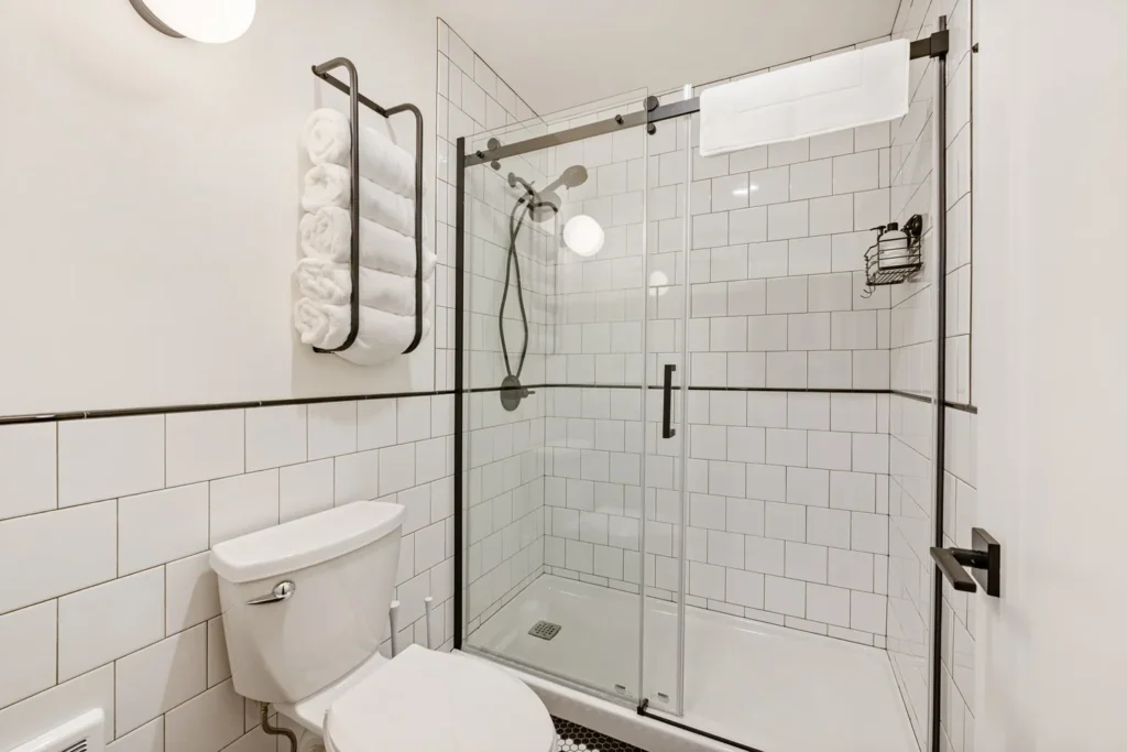 Modern bathroom with glass shower and white tiles