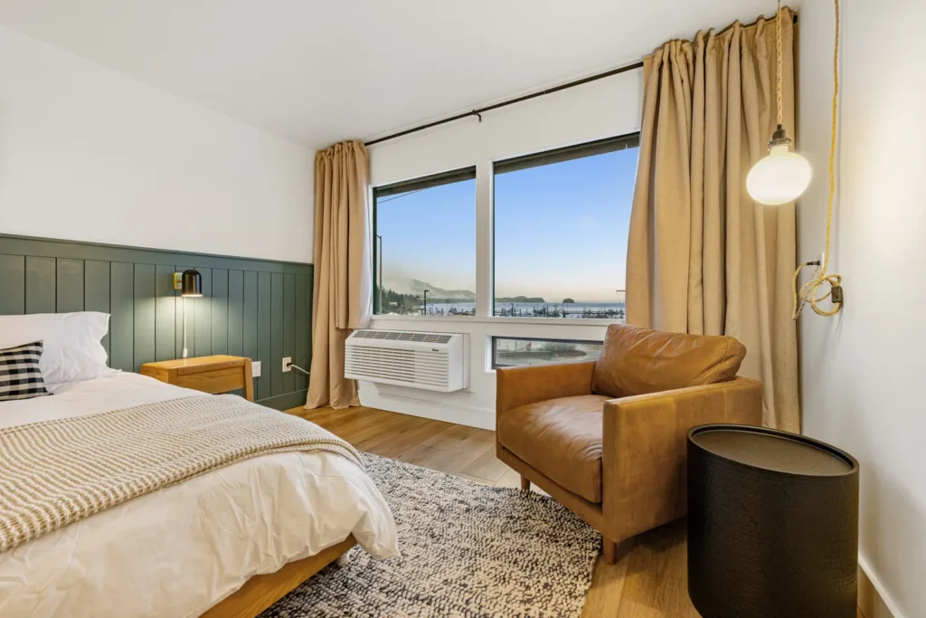 Cozy bedroom with ocean view window and armchair