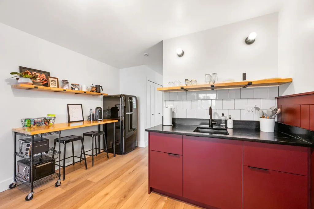 Modern kitchen with red cabinets and black countertop