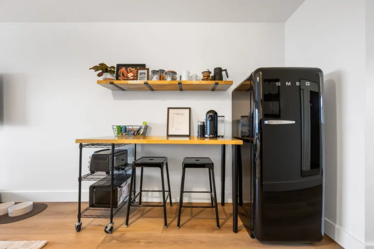 Modern kitchen corner with black SMEG refrigerator