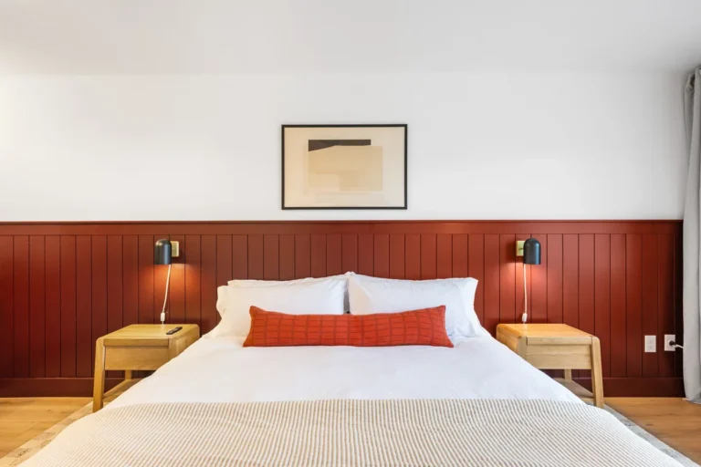 Modern bedroom with red headboard and white bedding