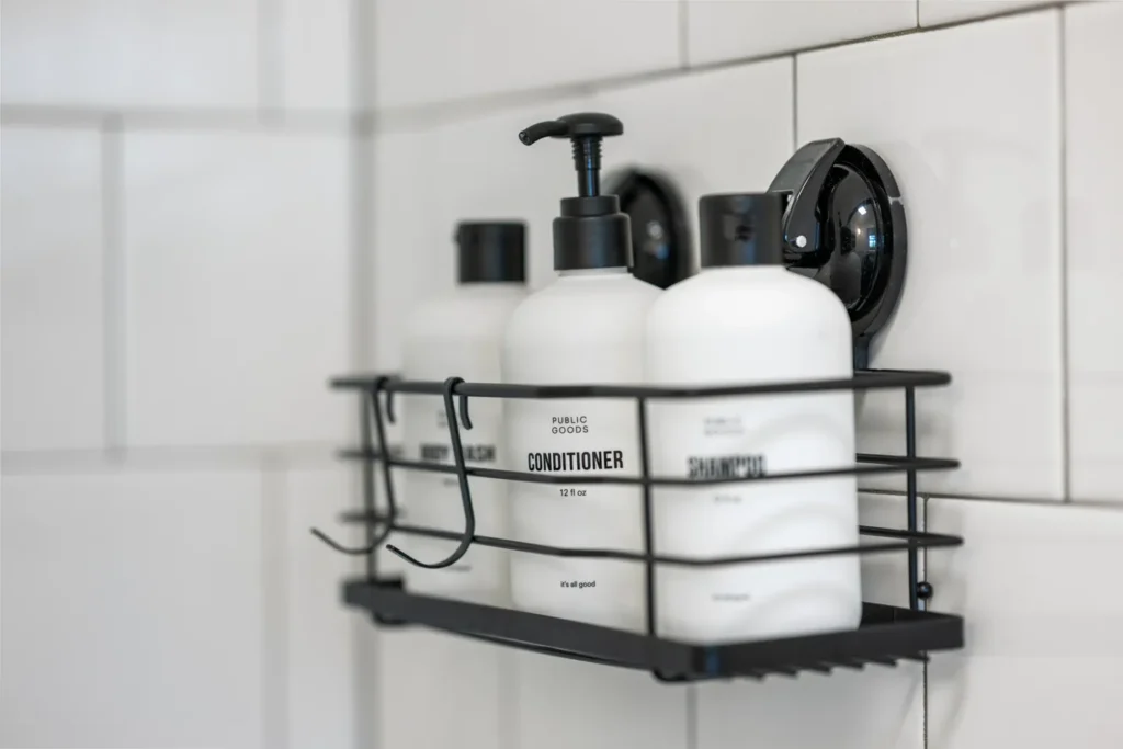 Shampoo and conditioner bottles on shower shelf