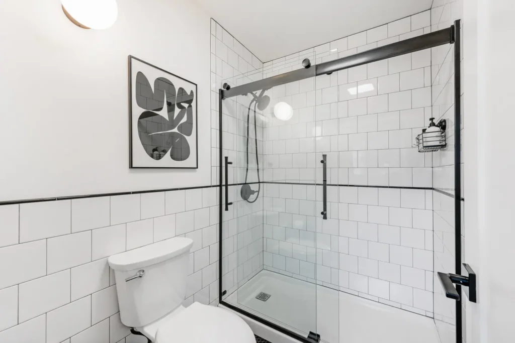 Modern white bathroom with glass shower enclosure