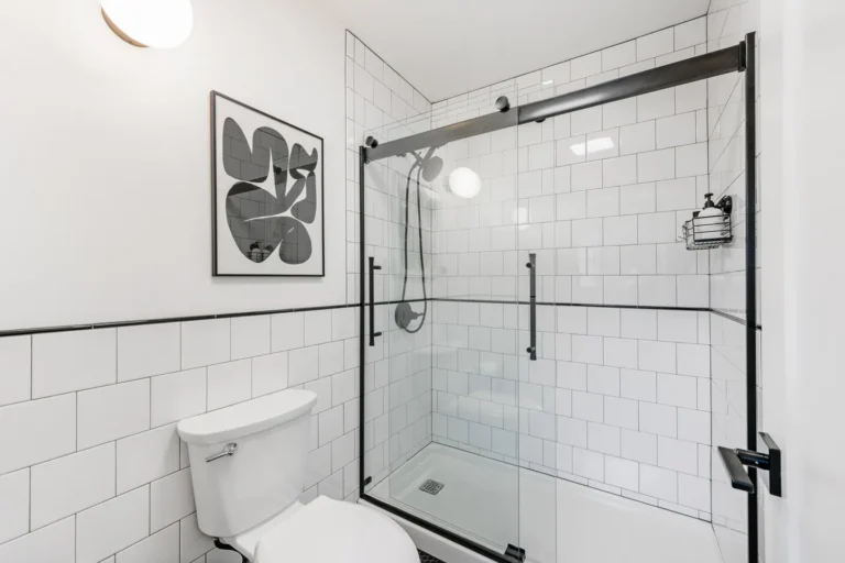 Modern white bathroom with glass shower enclosure