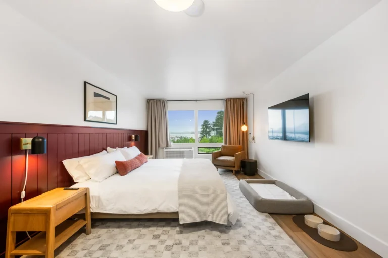 Modern hotel room with bed and window view