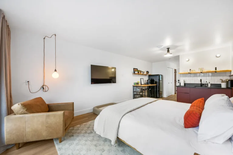 Modern studio bedroom with kitchenette and cozy decor