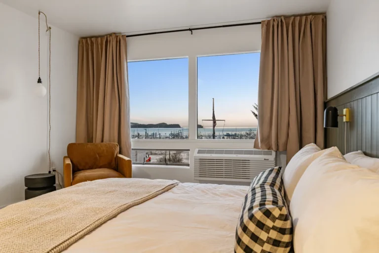 Cozy bedroom with ocean view at sunset