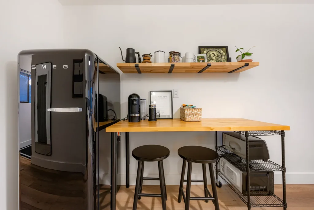 Modern kitchen corner with fridge and coffee station