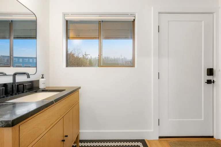 Modern bathroom with wood vanity and black fixtures