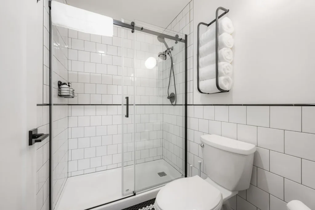 Modern white bathroom with glass shower enclosure