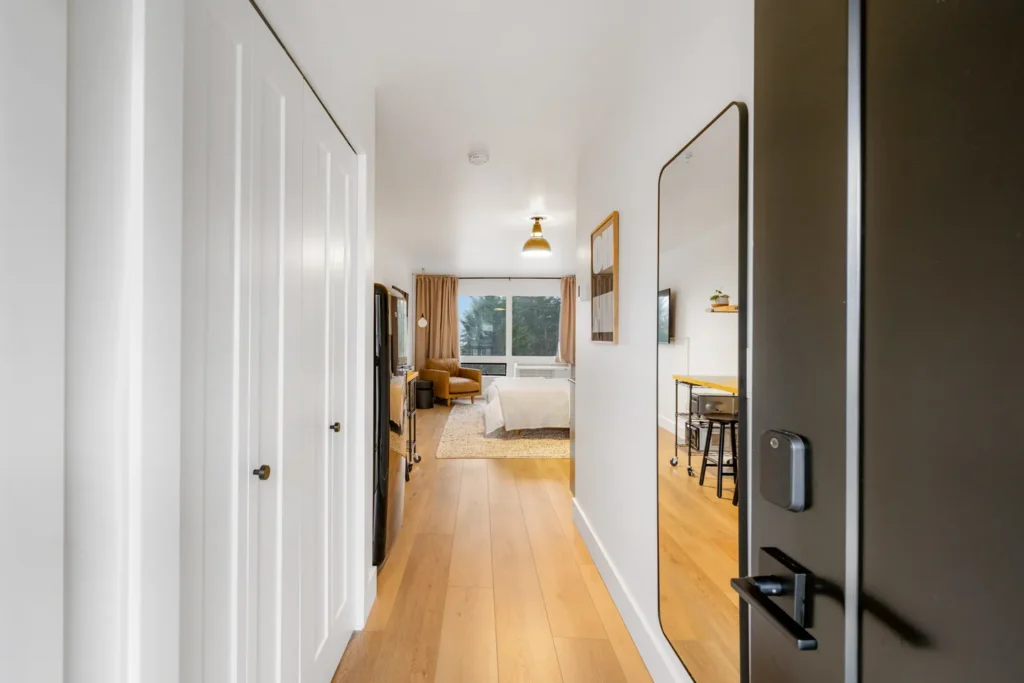 Modern studio apartment hallway with wood floors