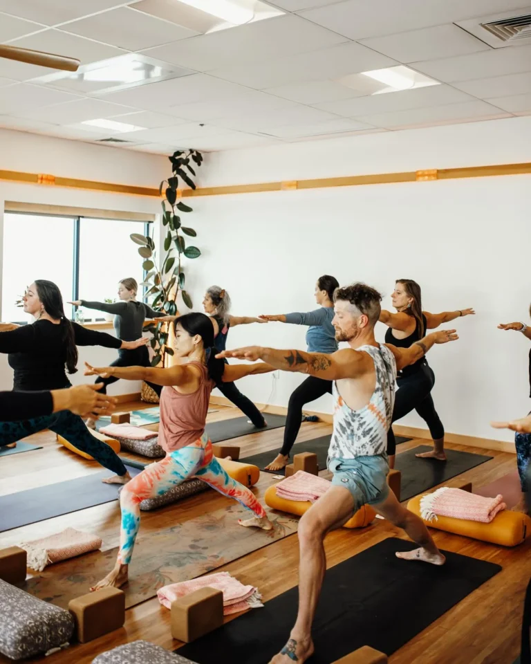 Group practicing yoga poses in studio class