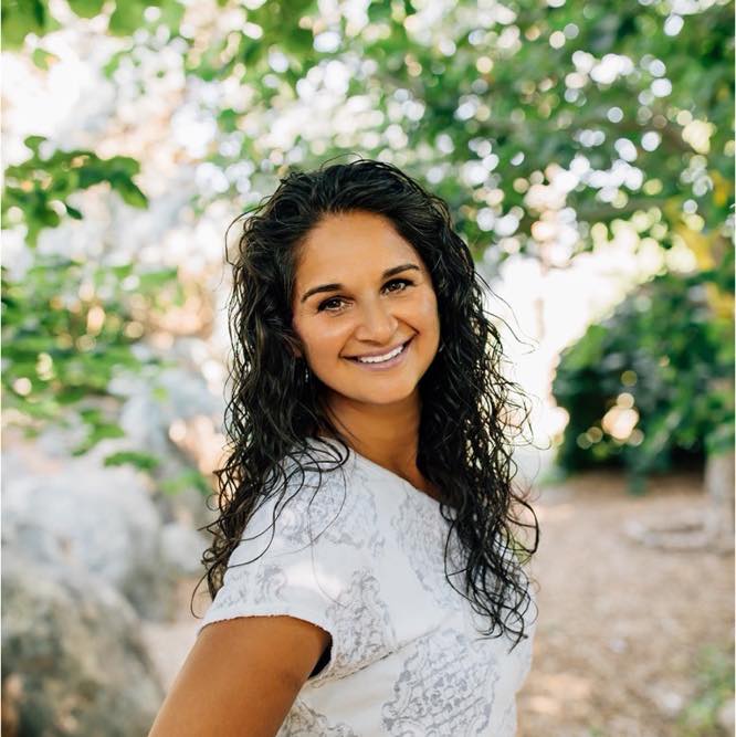 Smiling woman outdoors with curly hair
